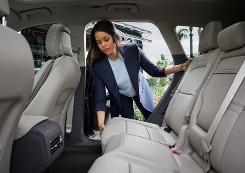 A woman slides the second-row seat forward to create more cargo space | Empire Lincoln in Abingdon VA