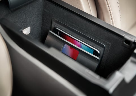 A smartphone device is securely tucked into the available wireless charging pad for an effortless energy boost | Empire Lincoln in Abingdon VA