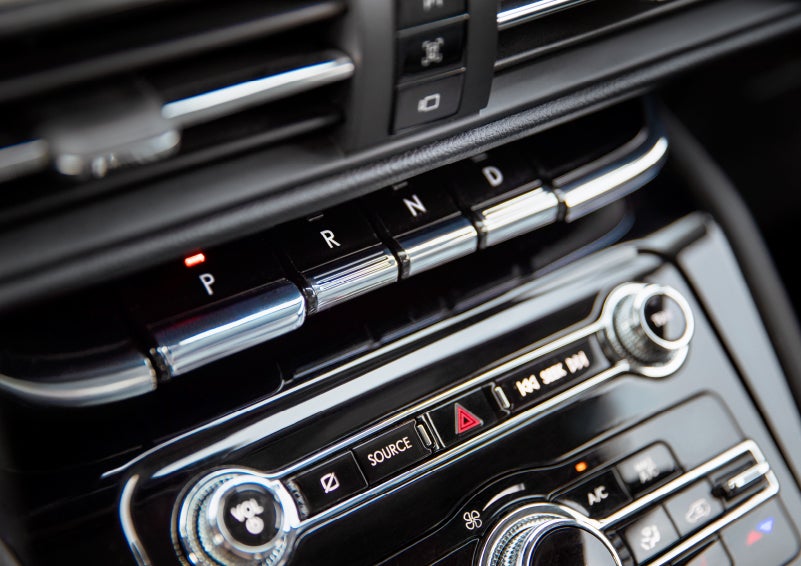 The Park button on the elegant Piano Key Shifter is lit up and engaged as light dances off the chrome accents and horizontal design lines | Empire Lincoln in Abingdon VA