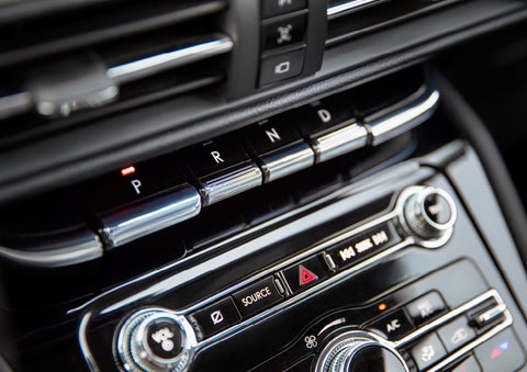 The Park button on the elegant Piano Key Shifter is lit up and engaged as light dances off the chrome accents and horizontal design lines | Empire Lincoln in Abingdon VA