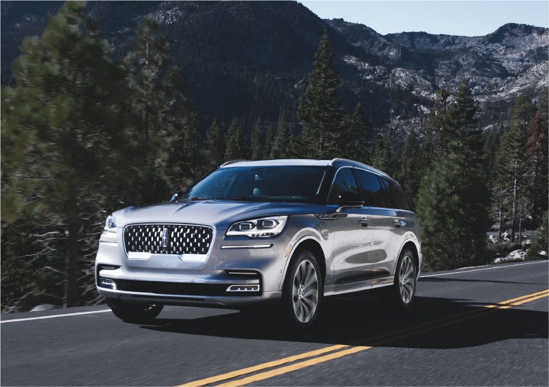 A 2023 Lincoln Aviator® Grand Touring SUV being driven on a winding road to demonstrate the capabilities of all-wheel drive | Empire Lincoln in Abingdon VA