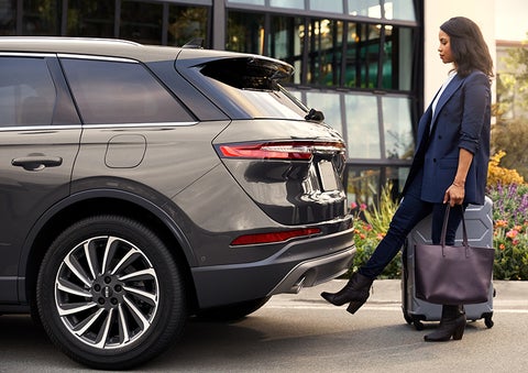 A woman with her hands full uses her foot to activate the available hands-free liftgate. | Empire Lincoln in Abingdon VA