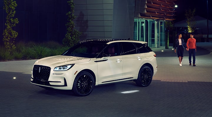 Two people approach a 2024 Lincoln Corsair® SUV featuring the available Jet Appearance Package. | Empire Lincoln in Abingdon VA