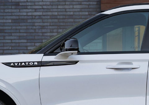 The driver’s side door and fender badging of a white 2026 Lincoln Aviator® SUV are showcased. | Empire Lincoln in Abingdon VA