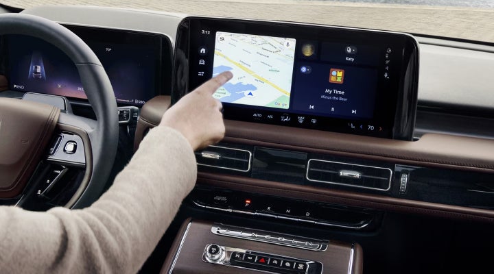 A person is tapping the center display touchscreen of a 2026 Lincoln Aviator® SUV. | Empire Lincoln in Abingdon VA