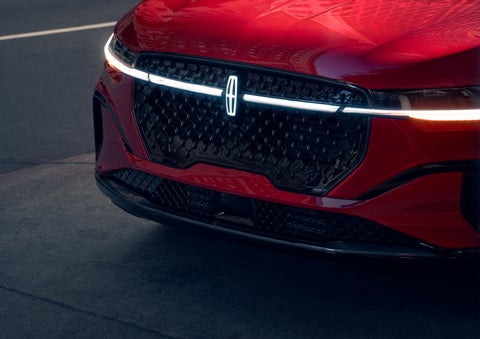 The available front LED light bar and center Lincoln Star logo glow at dusk. | Empire Lincoln in Abingdon VA