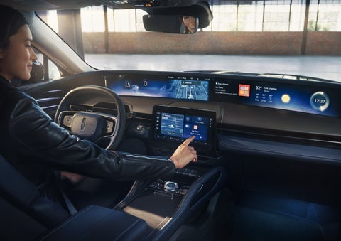 The driver of a 2026 Lincoln Nautilus® SUV interacts with the center touchscreen. | Empire Lincoln in Abingdon VA