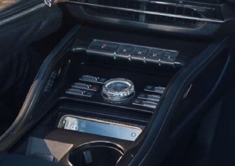 A smartphone is shown charging in the wireless charging pad. | Empire Lincoln in Abingdon VA